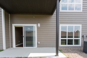 Outdoor patio with concrete platform, sliding glass door